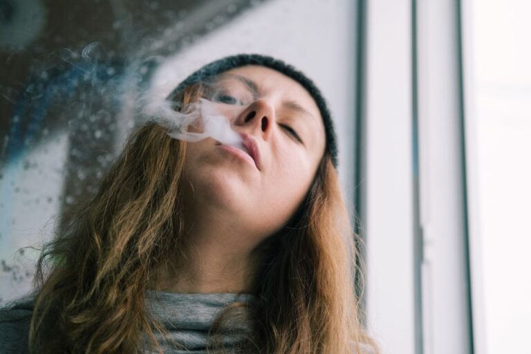 A lady smoking thca pre-roll and getting relaxed