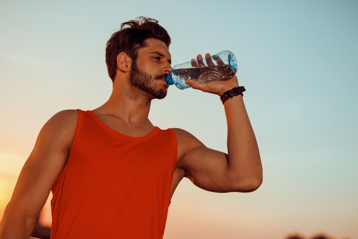 A person drinking plenty of water and doing exercise to get thca out of the body quickly